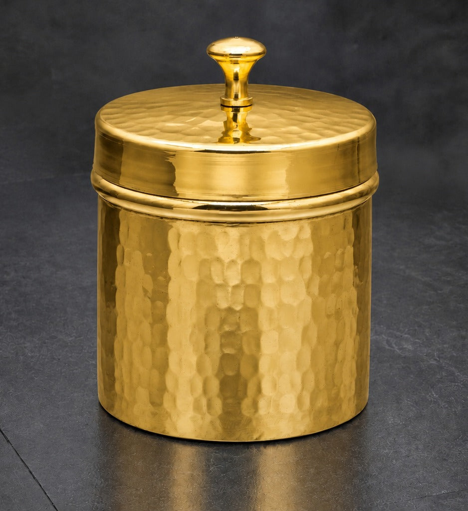 A cylindrical hammered metal canister with a matching lid and a small round knob, shown on a dark gray background.